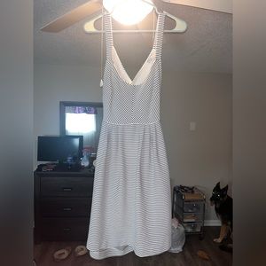Small white dress with black stripes. Crossed strap back